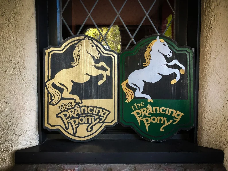 The Prancing Pony pub signs.