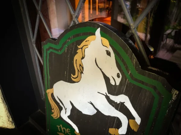 Here's an alt tag for the image: White horse pub sign.