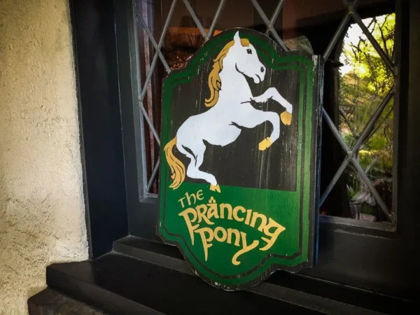 Here's an alt tag for the image: The Prancing Pony sign.