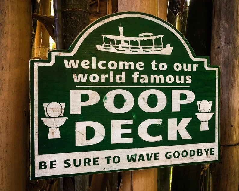 Here's an alt text option: World famous poop deck sign.