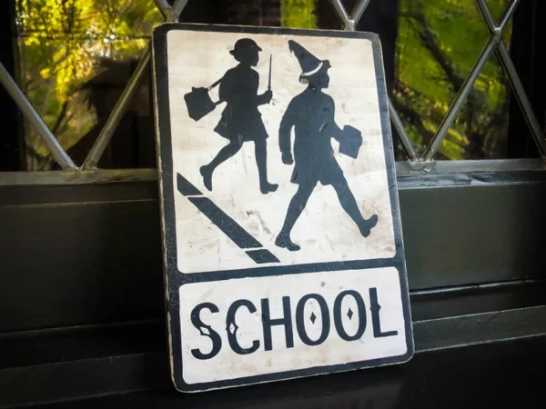 School crossing sign: children walking.