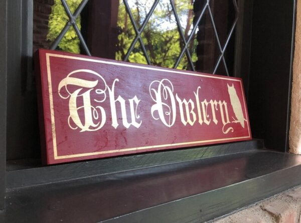 Here's an alt tag for the image: `The Owlery sign with owl`