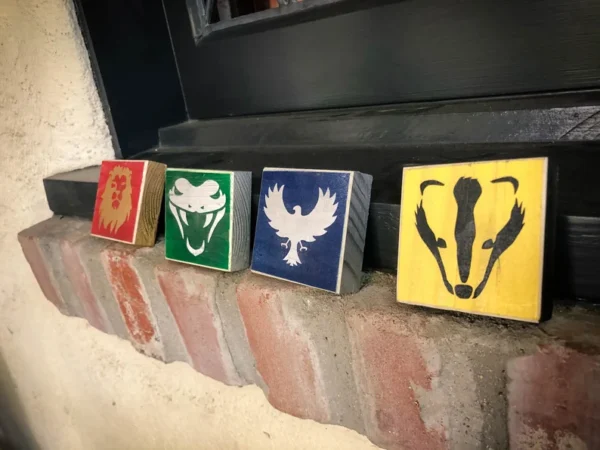 House crests: lion, snake, eagle, badger.