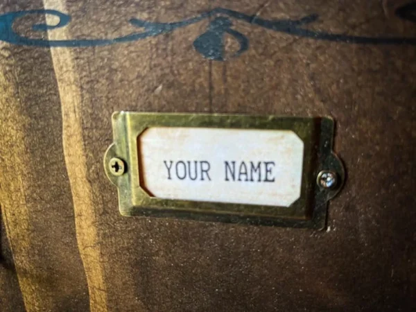 Wooden box with brass nameplate.