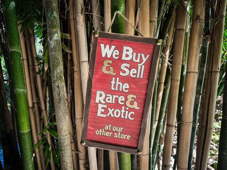 Here's an 8-word alt tag for the image: Sign: We buy & sell rare and exotic items.