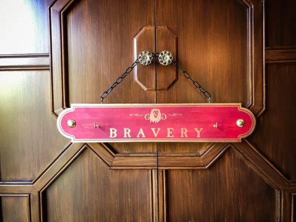 Red bravery sign on wood door.