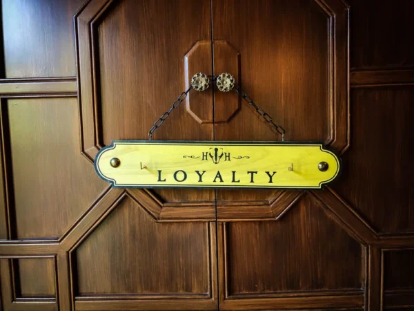 Yellow loyalty sign on wooden door.