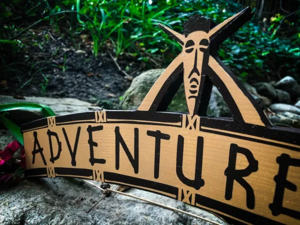 Adventure sign with tribal mask.