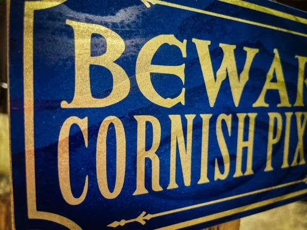 Here's an alt tag for the image: Beware Cornish pixies sign.