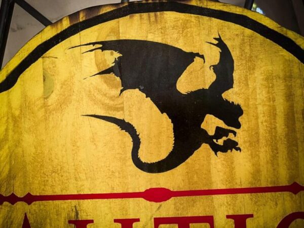 Black dragon silhouette on gold shield.