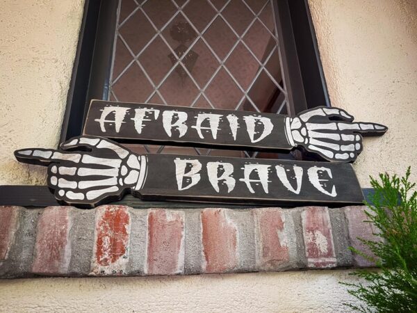 Skeleton hands point: Afraid or Brave.