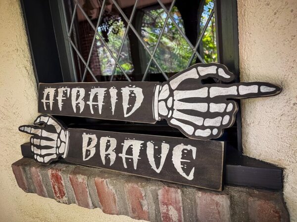 Afraid or brave Halloween skeleton sign.