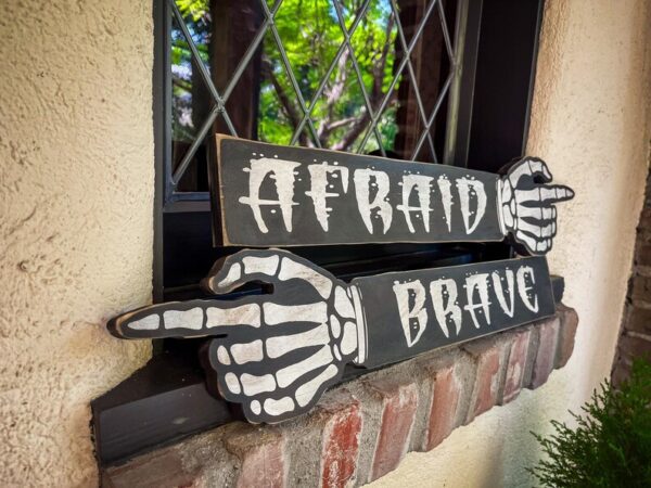 Skeleton hands point: Afraid, Brave.