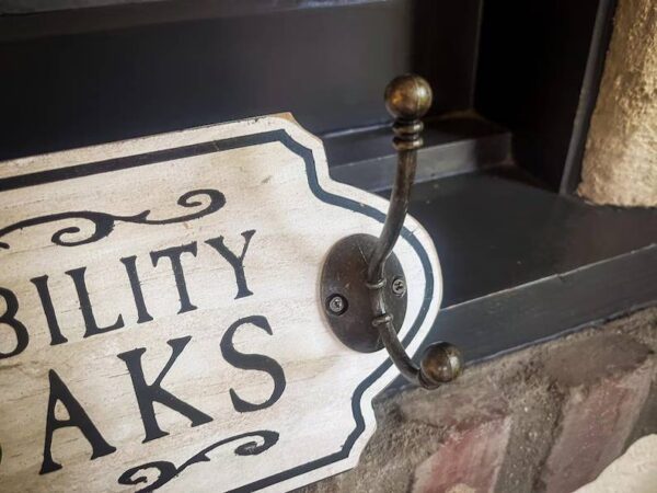 Here's an alt tag for the image: Accessibility hooks sign.